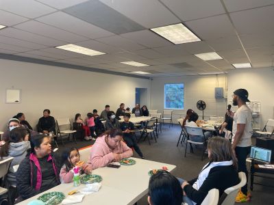 Residents surrounding tables during idea collection session